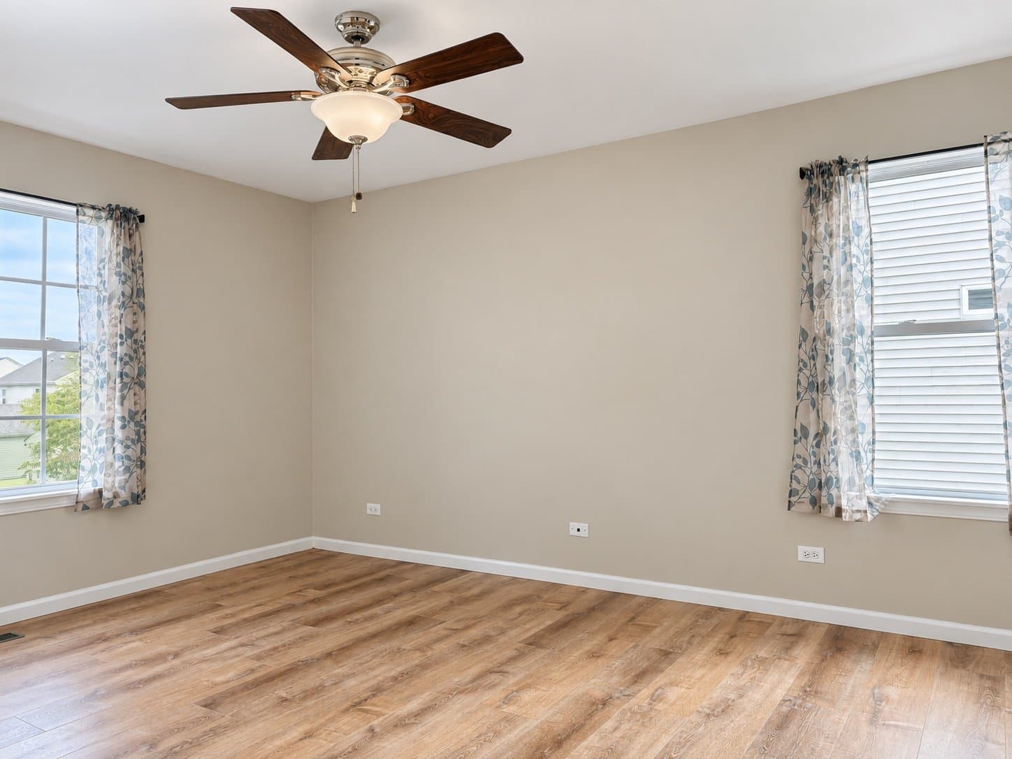 Bedroom with ceiling fan and new flooring (2026)